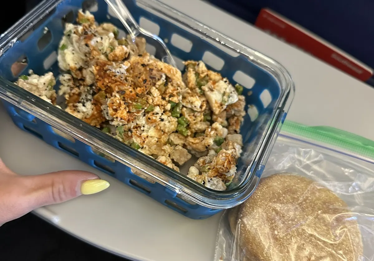 A packed high-protein meal on a flight tray table
